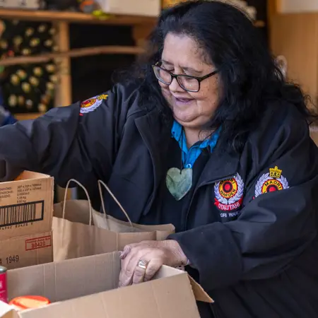 Image of a women packing food in boxes