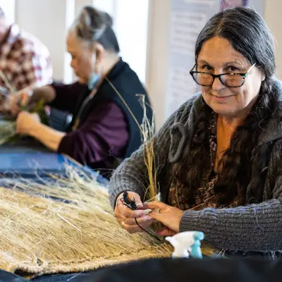Image of a women making a flax skirt